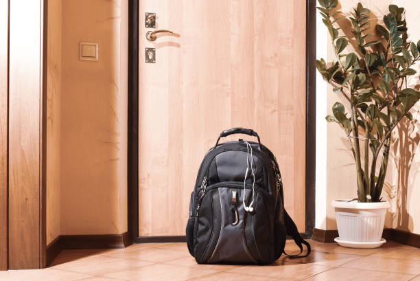 A colorful backpack sitting by a doorway, ready for travel to Mérida